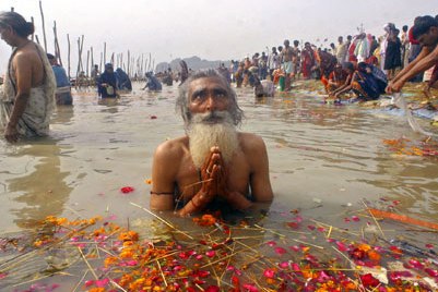 A man prays in the Ganges River